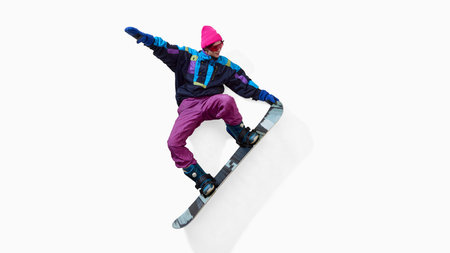 Snowboarder performing grab trick in colorful retro outfit isolated on white backgroundの写真素材