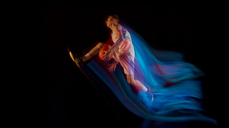 Basketball player flying midair with ball and blue motion streaks showing athletic power