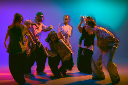 Street dancers performing in motion blur neon lights