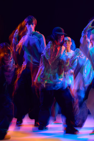 Young dancers in colorful hip hop performance with motion blur