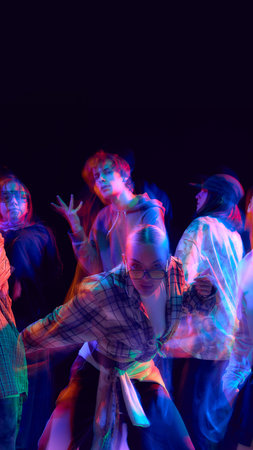Dancers with neon motion blur in expressive hip hop performance.の写真素材