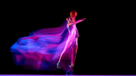 Basketball player jumping with glowing ball and neon motion trails.の写真素材
