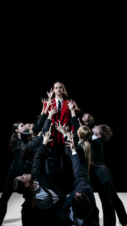 Leader in red coat elevated above group as symbolic model for leadership training and team education