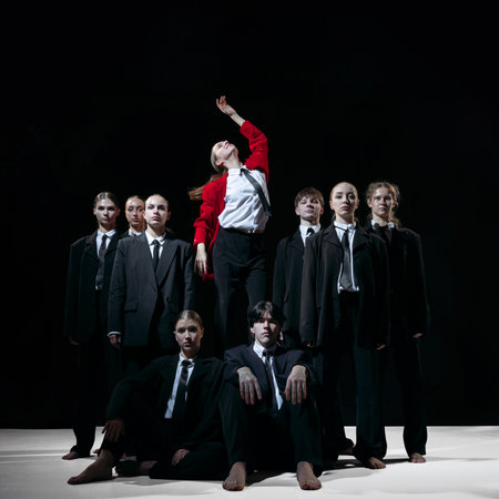 Leader in red coat standing above team symbolizing visionary direction and disruptive startup energy