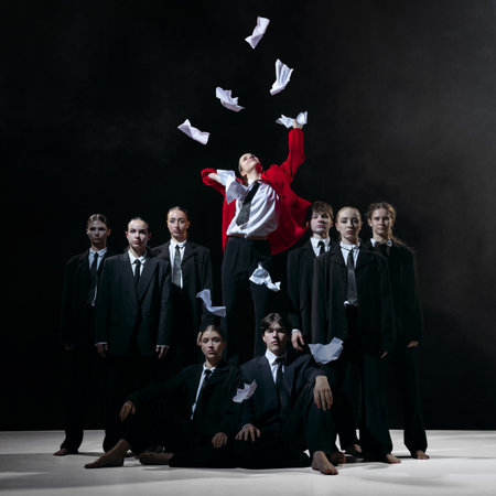 Leader in red coat throwing papers as metaphor for burnout, resignation and HR communication themesの写真素材