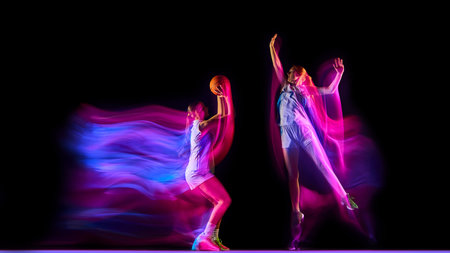 Two basketball players facing each other in glowing neon motion blur.の写真素材