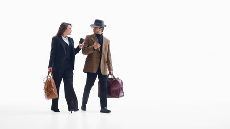 Business colleagues walking together with travel bags and positive moodの写真素材