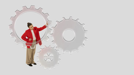 Creative composition. Businesswoman inside gear mechanism adjusting system with confident emotionの写真素材