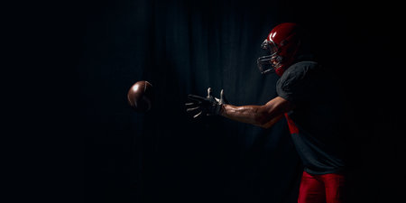 Football player reaching forward for ball with intense emotional urgency. Bannerの写真素材