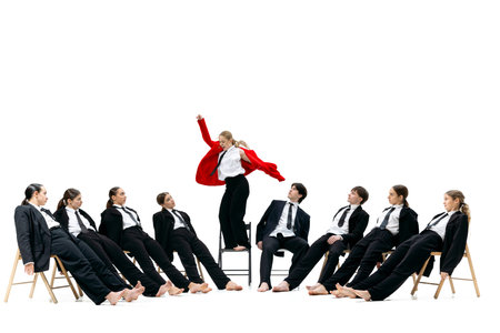 Business woman in bright red jacket standing boldly above team expressing strong leadership