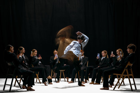 Motion-blurred performer moving energetically while surrounded by colleagues recording with...