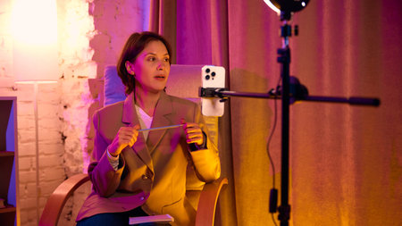 Woman talking while holding pencil in digital coaching setup