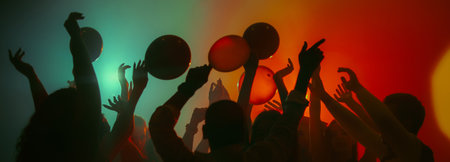 Dancing silhouettes with balloons in colorful party atmosphere. Bannerの写真素材
