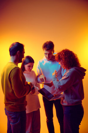 Startup team reviewing digital product roadmap on shared tabletの写真素材