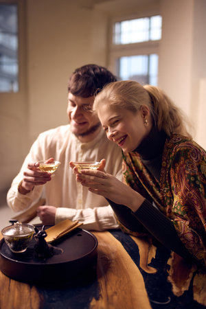 Smiling couple enjoying freshly brewed tea together at home