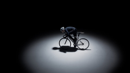 Minimalist cyclist racing in dark studio with large copy space.の写真素材