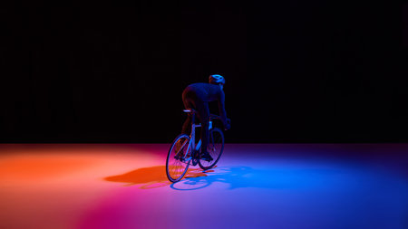 High performance cycling athlete in dynamic neon studio scene.の写真素材