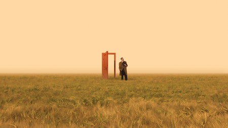 Conceptual poster man stepping through open door in field.の写真素材