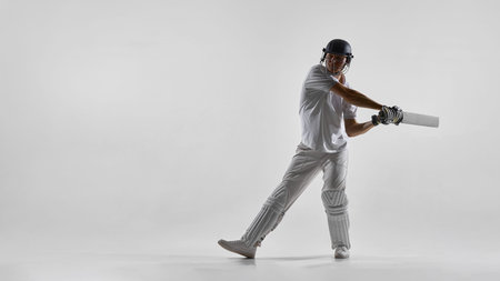 Cricket batsman executing front foot shot isolated on white background