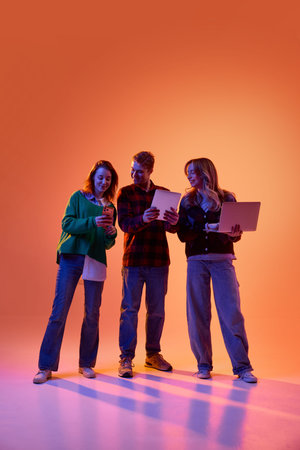 Three colleagues reviewing fintech app data on multiple devices.