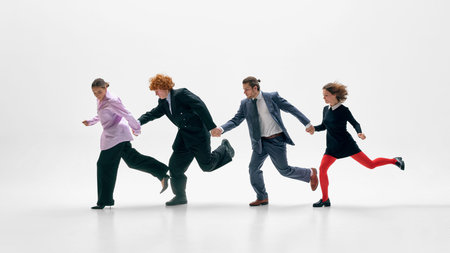 Contemporary business team running forward in stylish office attire on white background.