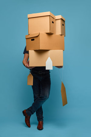 Man hidden behind stack of cardboard price tag boxes retail concept