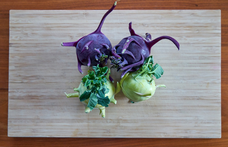 Four Raw Kohlrabi on A Bamboo Boardの写真素材