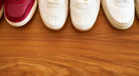Top View Of Three Pair Of Red And White Sneaker Shoes On A Wooden Surface Top Viewの写真素材