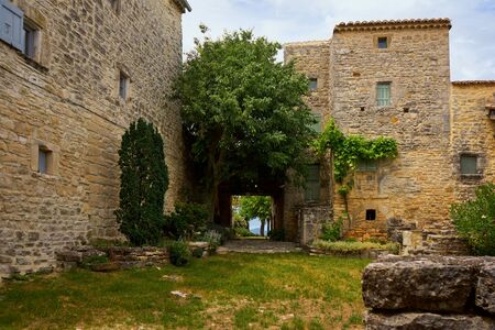 Medieval Bulding With Old Tree And Stone Porch at Cabiac Occitanie Franceの写真素材