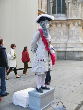 Milan, Italy, October 15, 2010- An unidentifed street performer attracts attention as a human statue, dressed in 18th century period costume in Piazza del Duomo just steps away from Duomo di Milano and Galleria Vittorio Emanuele II. The fashion capitalのeditorial素材
