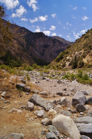 Landscape with mountains and desert blue sky background, a hiking path leads across the nearly dry creek bed through Big Rock Canyon, の写真素材