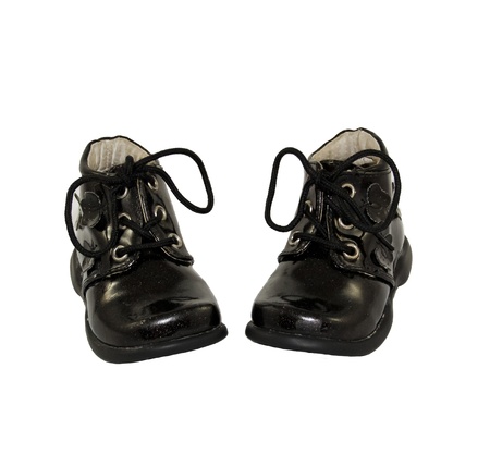 cute black baby shoes isolated on white backgroundの写真素材