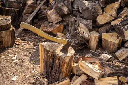 Wood axe and wood pile outdoor woodcutter logs.の写真素材