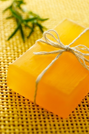 Handmade golden yellow colored soap with rosemaryの写真素材