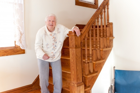 Senior woman standing in front of stairsの写真素材