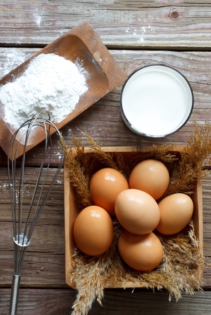 Eggs, flour and milk with whiskの写真素材