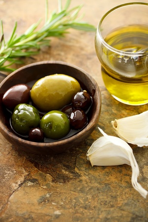 Olive oil and mixed olives with garlic clovesの写真素材