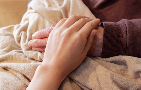 Old and Young Hands on Brown Blanketの写真素材