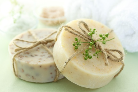 Bars of soap with bath salt and towelsの写真素材