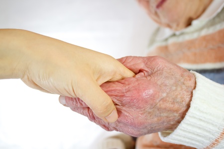 Senior and young women holding handsの写真素材