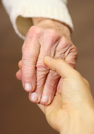 Senior and young women holding handsの写真素材