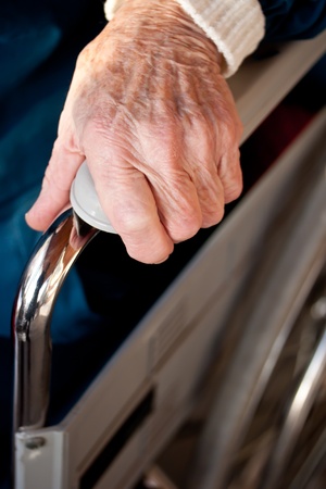 Senior womans hand on a wheelchairの写真素材
