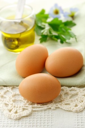 Fresh Eggs with Olive Oil on Tableの写真素材