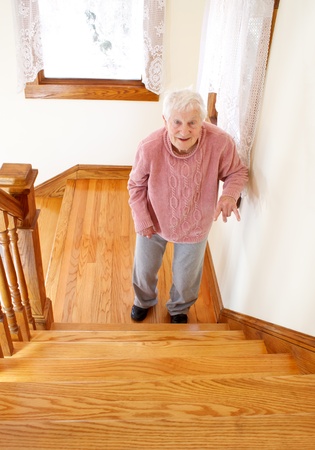 Senior woman infront of staircaseの写真素材
