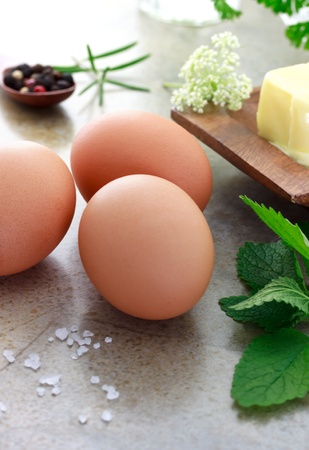 Eggs with rosemary, parsley, mint, peppercorn and butterの写真素材