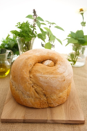 Loaf of bread with collection of herbsの写真素材