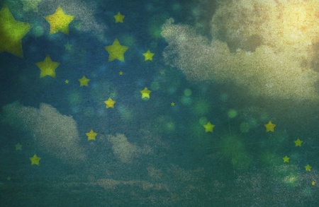Stars and clouds in the night sky in grunge and vintage styleの写真素材