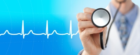 Doctor with stethoscope on the electrocardiogram graph backgroundの写真素材