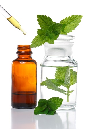 Herbal medicine dropper bottle with mint leavesの写真素材