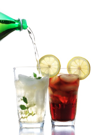 Ginger ale and cola in the glasses with lemon garnishの写真素材
